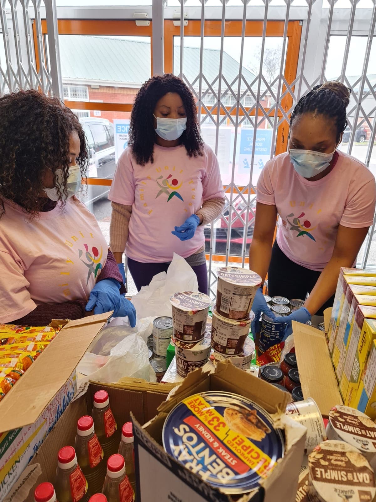 Family Unit Trust volunteers sorting food parcels at the Food Bank.