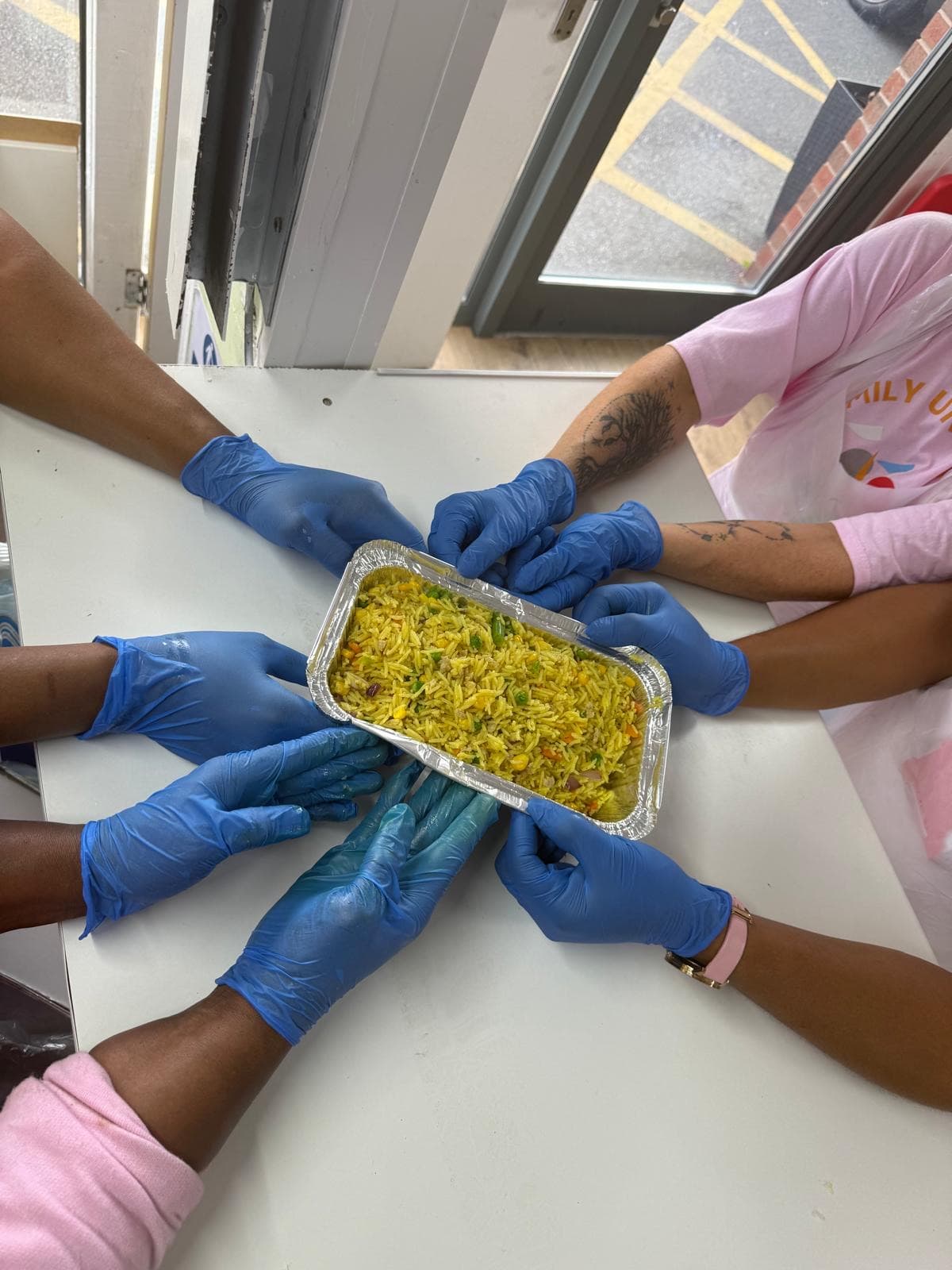 Family Unit Trust volunteers plating up freshly cooked meals at Taste of Home.
